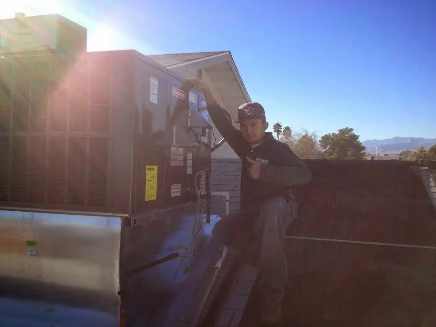HVAC technician performing Boiler Repair on a rooftop unit in Trenton